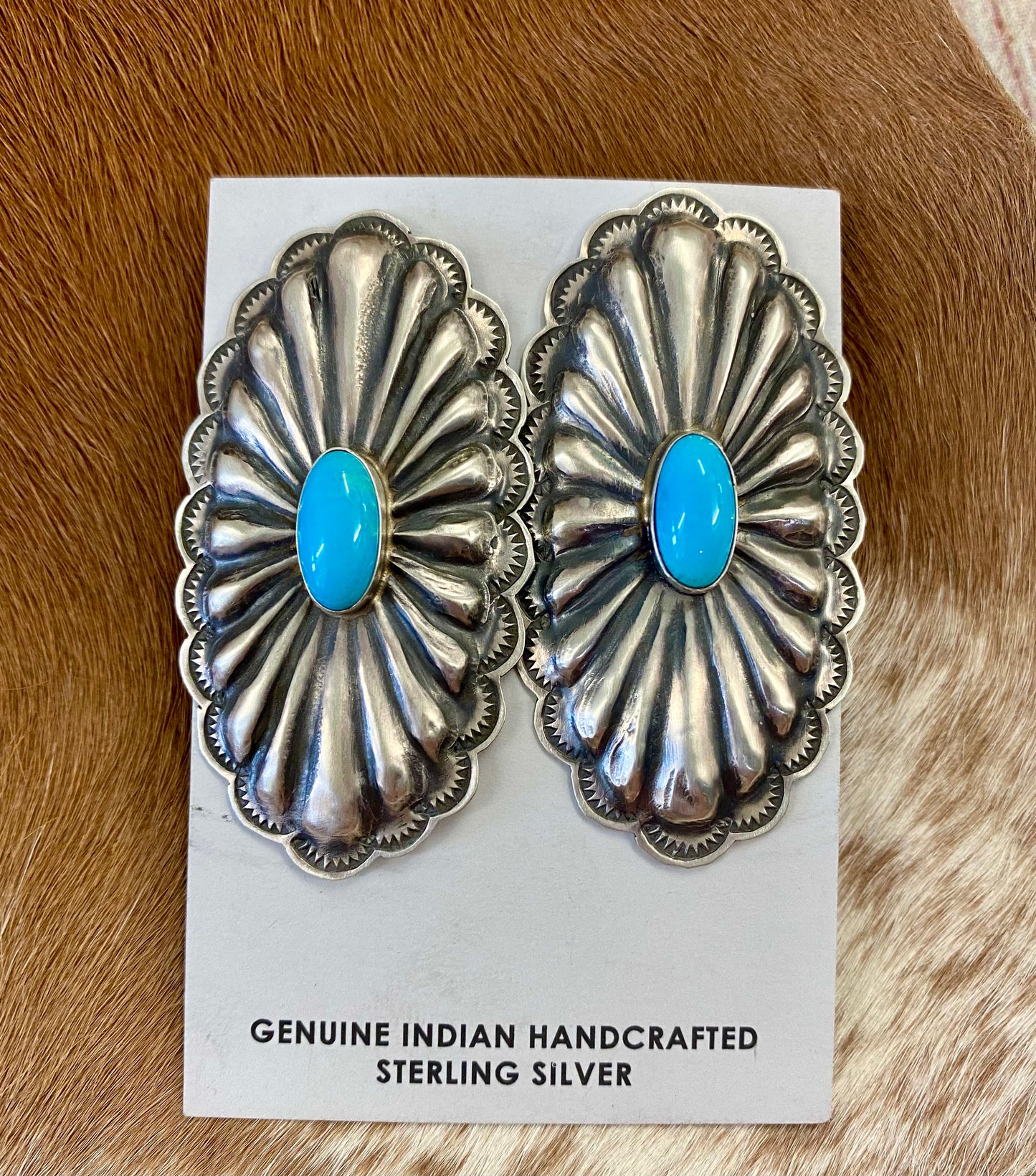 Beautiful large statement Concho sterling silver sleeping beauty turquoise earrings with single stone pieces of turquoise in the center. Stamped sterling and signed by Native American artist silversmith Rita Lee. The perfect set of earrings to add in to anyone's jewelry collection. Dress them up or down! Size: 2 1/2" Inches Long x 1 1/4" Inches Wide Hallmark/Artist: Rita Lee Stone: Turquoise