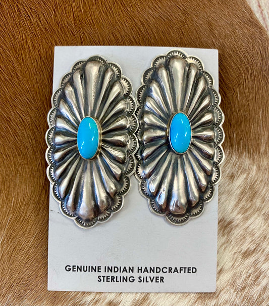 Beautiful large statement Concho sterling silver sleeping beauty turquoise earrings with single stone pieces of turquoise in the center. Stamped sterling and signed by Native American artist silversmith Rita Lee. The perfect set of earrings to add in to anyone's jewelry collection. Dress them up or down! Size: 2 1/2" Inches Long x 1 1/4" Inches Wide Hallmark/Artist: Rita Lee Stone: Turquoise