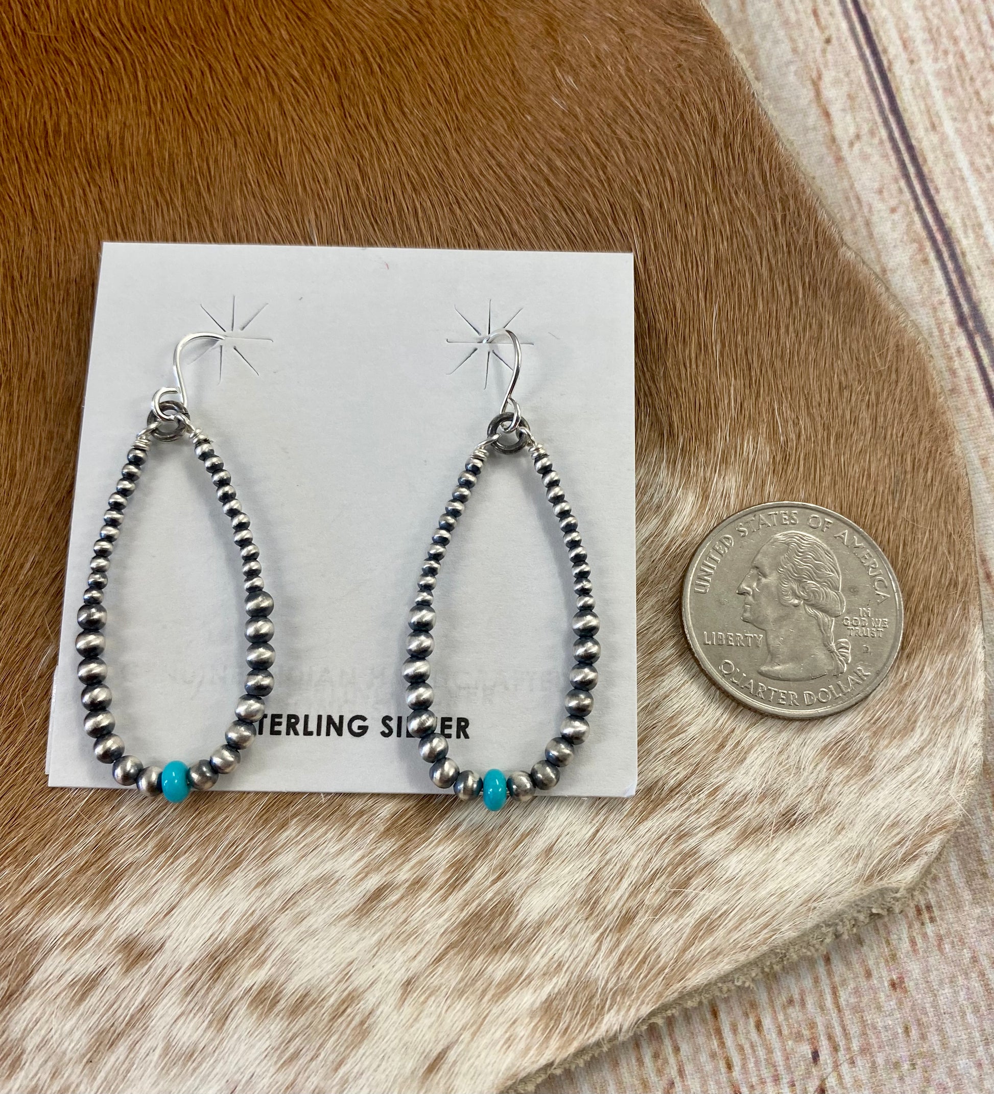 Simple lightweight and gorgeous authentic hand-strung Navajo Pearl sterling silver teardrop earrings with a turquoise stone on the bottom of each earring. Hook-closure earrings are perfect for everyday casual outfits and dressed-up ones.   Size: 1.5" inches length earrings.  Stone: Navajo Pearl & Turquoise