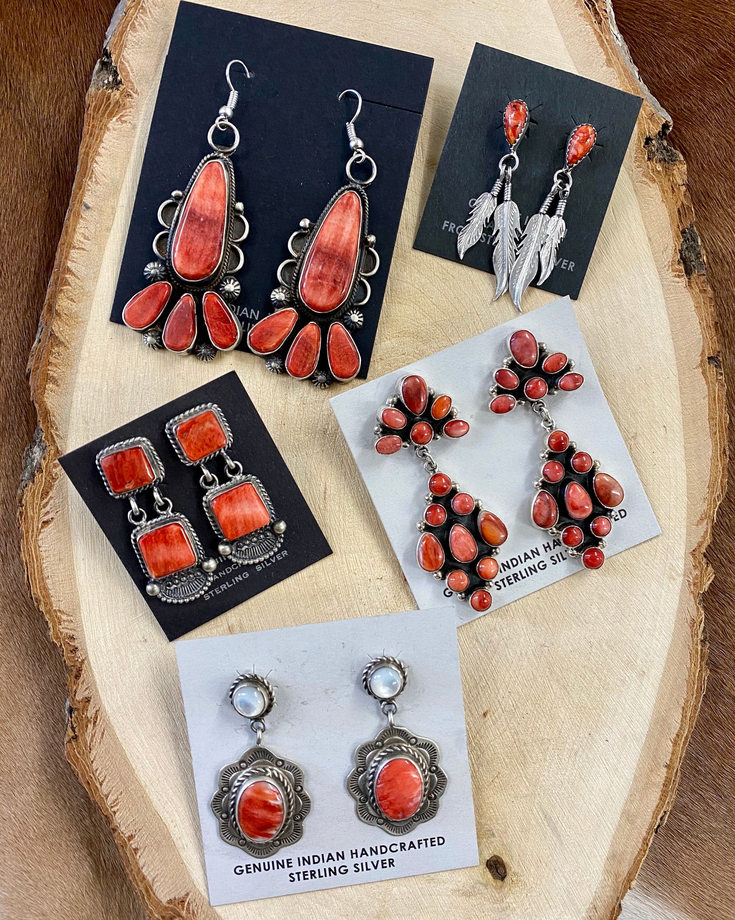 The O.A. Spiny Oyster Earrings - Ny Texas Style Boutique Red orange Spiny Oyster post sterling silver earrings. Stamped sterling and signed by Native American artist silversmith Oscar Alexius on the back. The perfect pop of color for any outfit! Size: 1.25” Inches Length Stone: Spiny Oyster Singed: YES "O.A." Hallmark/Artist: Oscar Alexius