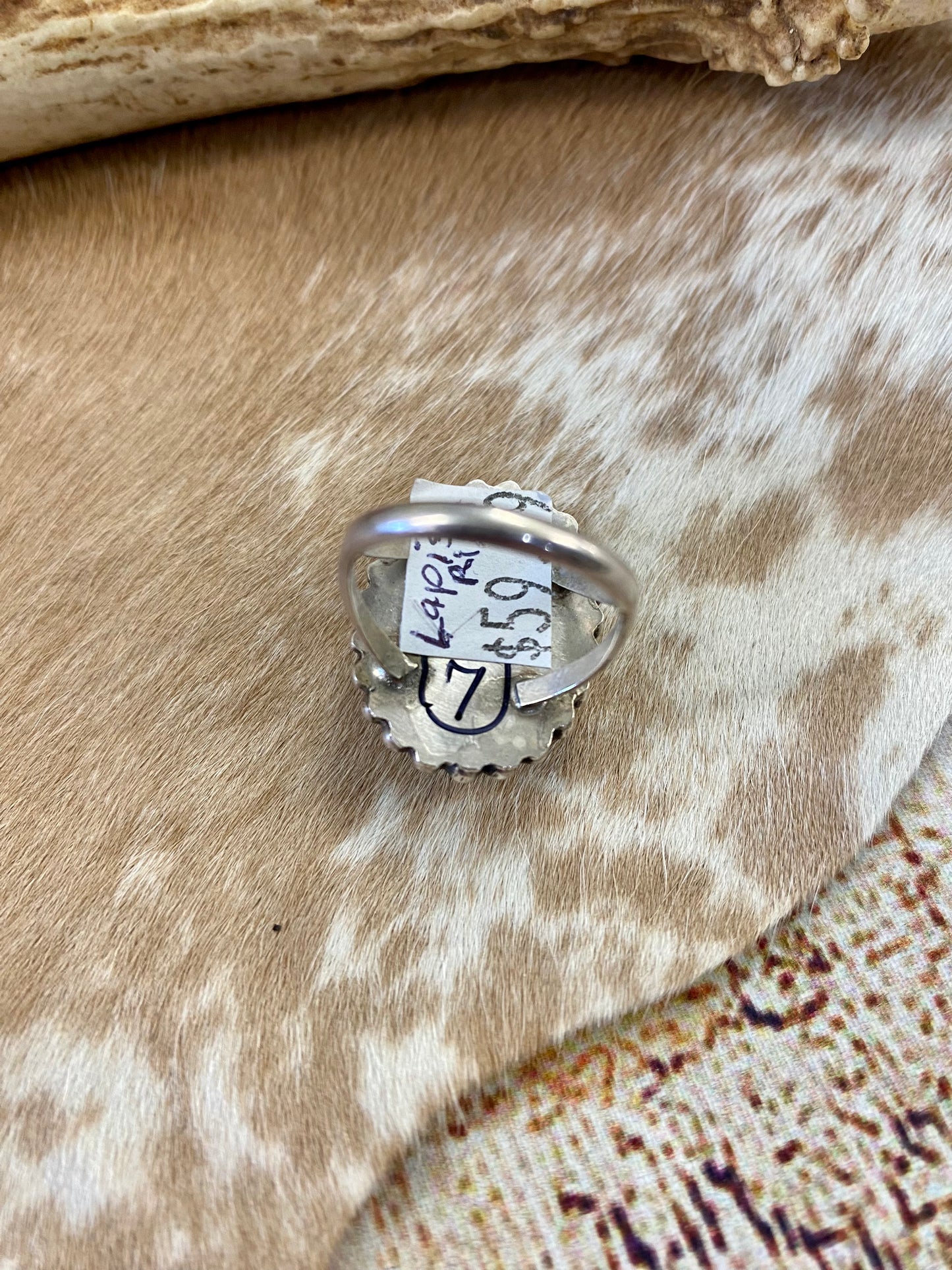 Beautiful single stone simple yet striking sterling silver blue lapis round size 7 ring. This piece is stamped Sterling and signed B on the back by Native American artist silversmith. A gorgeous ring that will add a pop of color to any outfit. Signed: YES “B” Ring Size: 7 Size: 1” inch length Stone: Blue Lapis