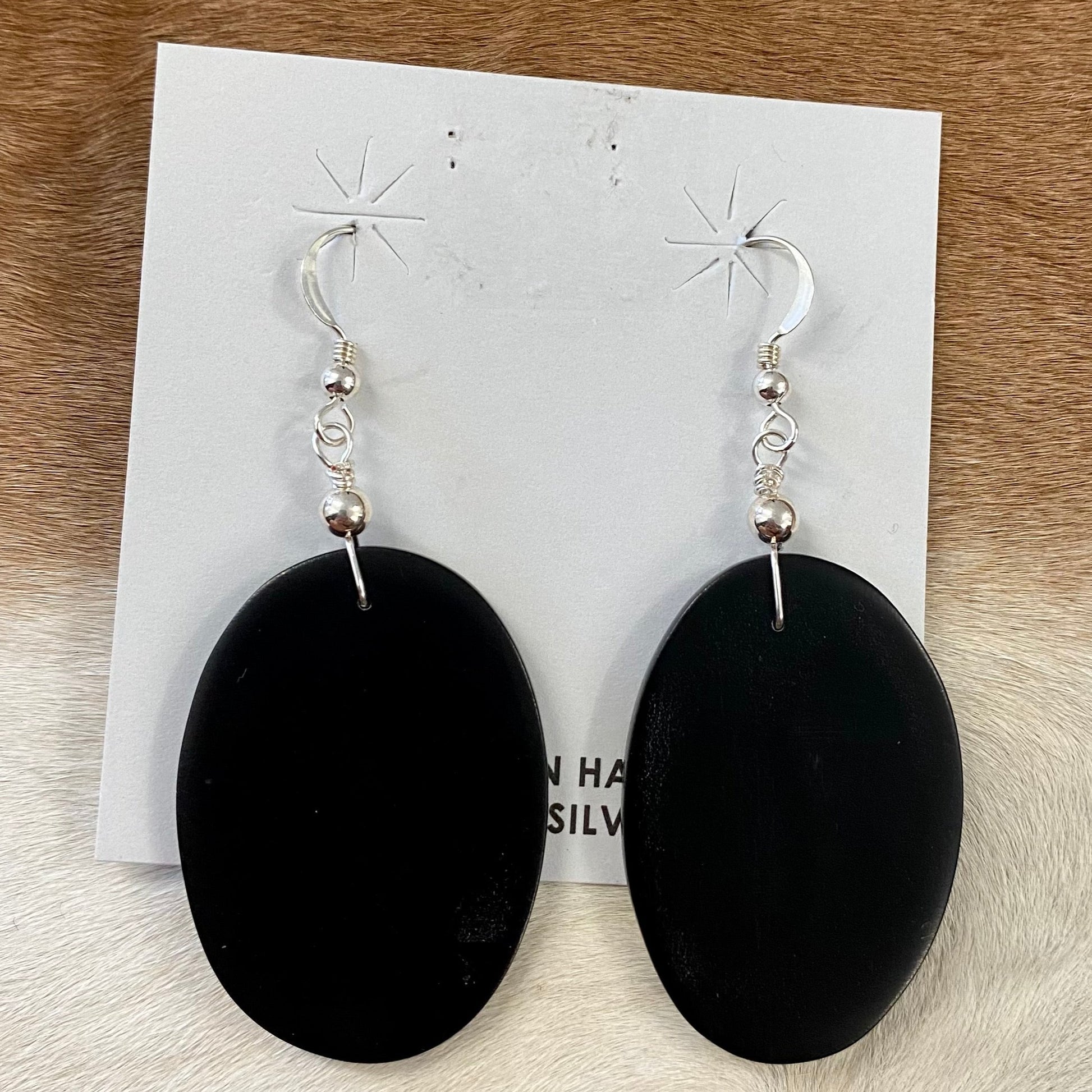 Jet black slab style hook authentic handmade sterling silver earrings. These earrings are gorgeous and simple.   What is the stone Jet?  Jet is a velvety black-colored gemstone that is a type of lignite. Jet is derived from decaying wood that undergoes extreme pressure and heat. The wood then becomes fossilized as a compact black material.The Alluring Jet Gemstone Earrings | Native Made Earrings