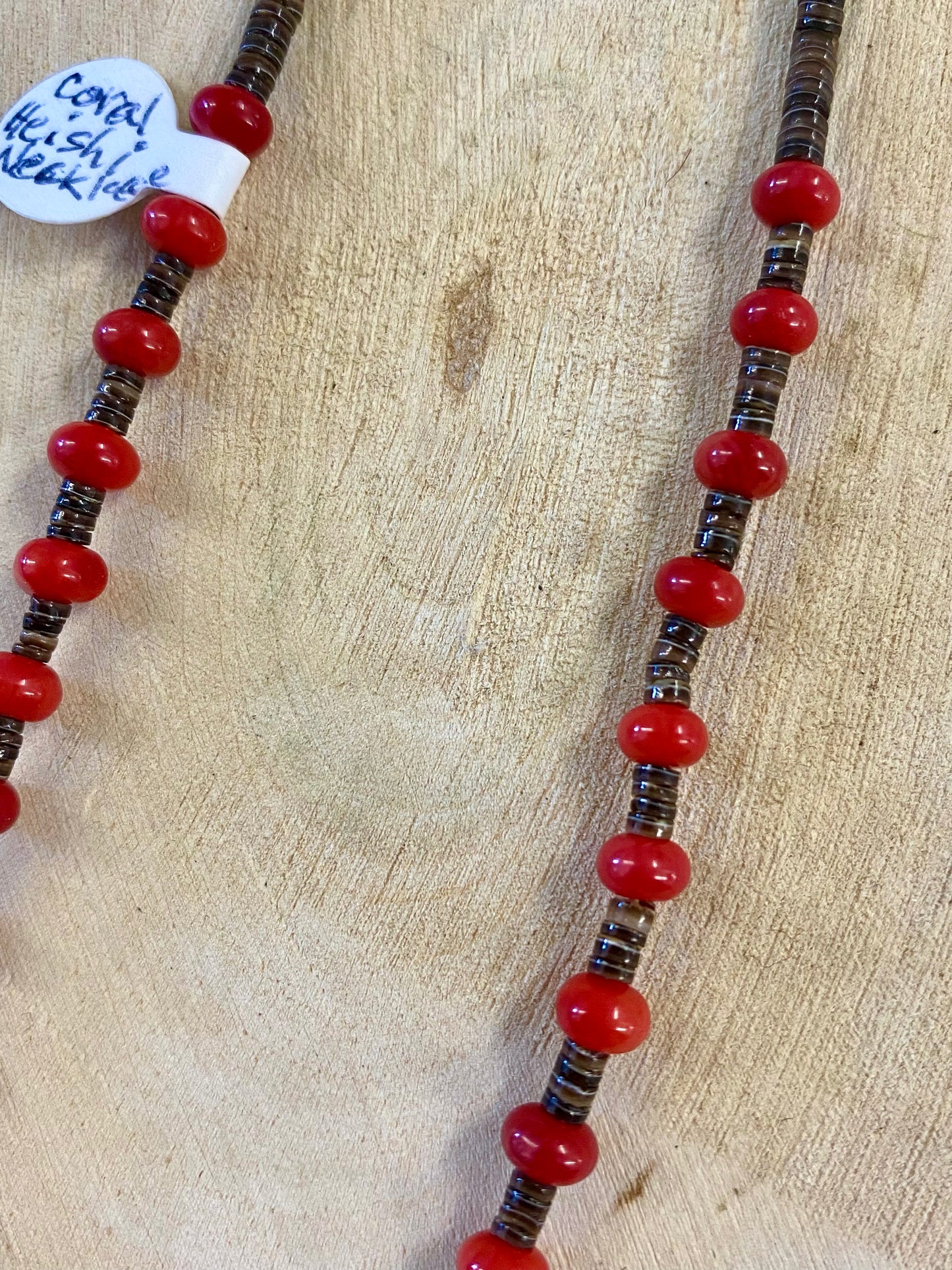 Red coral and brown heishi single strand choker length sterling silver native strung necklace. The perfect piece to layer with other necklaces or wear alone. Mix and match with other stone jewelry or stay with coral! Size: 14" Inches Stone: Coral