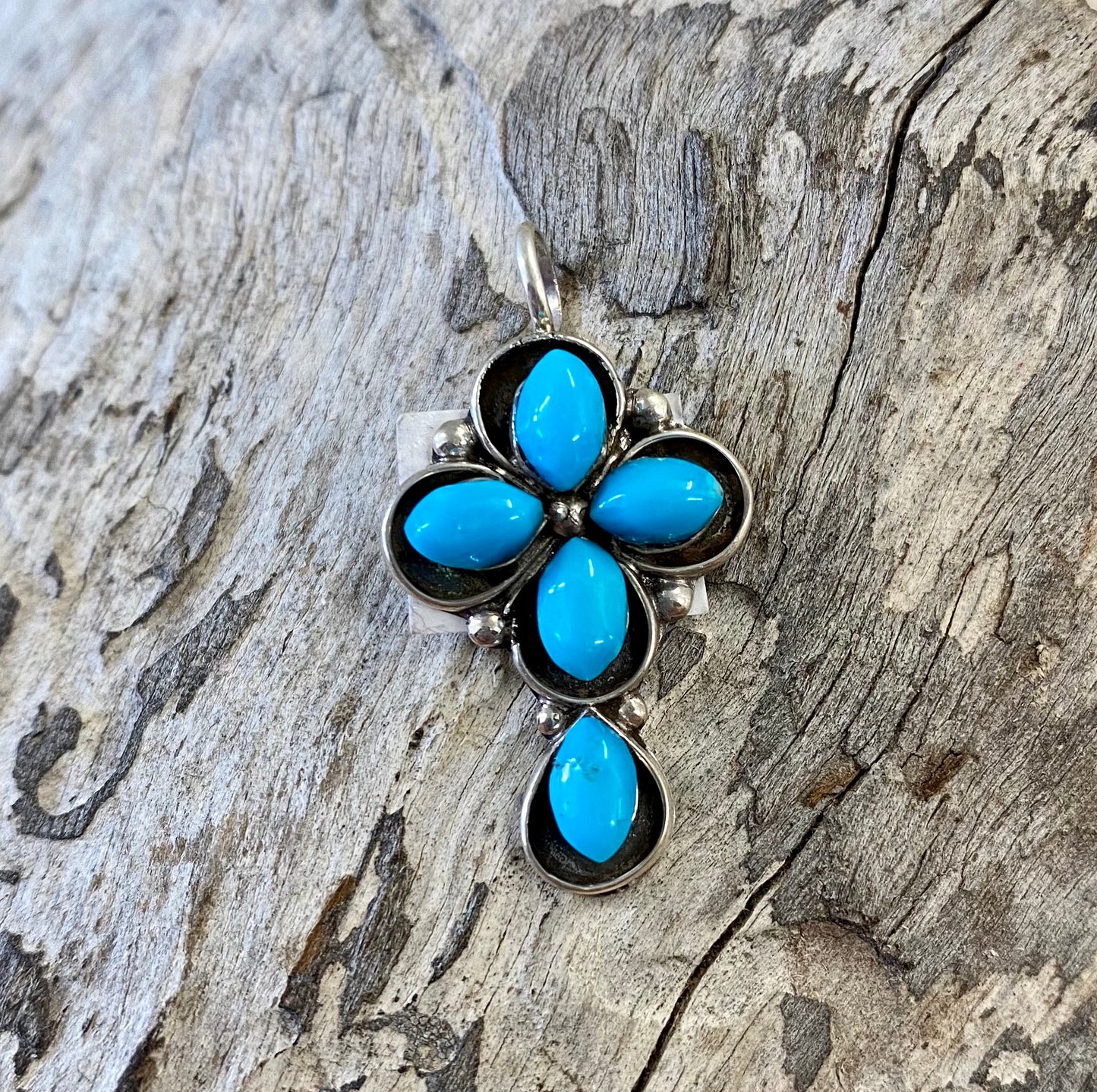 Small turquoise cross pendant/ charm handmade with Sterling Silver. The perfect addition to any charm bracelet or re strung on to a strand of Navajo Pearls. Beautiful addition to your everyday jewelry. The perfect piece to give us a gift to your loved one or keep for yourself!