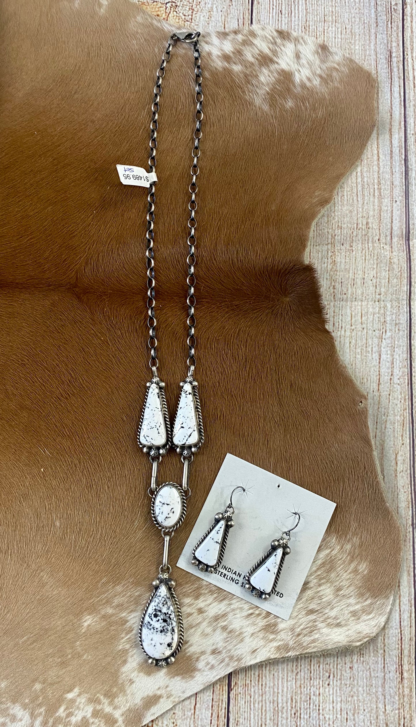 Stunning White Buffalo lariat style sterling silver Native American made necklace and drop hook matching White Buffalo sterling silver earrings set. The perfect jewelry set to gift to your loved one or keep for your own jewelry collection! Both pieces are stamped sterling and signed on the back by talented artist silversmith Annie Spencer. Size: 27” inches in length necklace + 1 1/2” inch earrings Stone: White Buffalo Signed: YES "AL" Artist / Hallmark: Annie Spencer