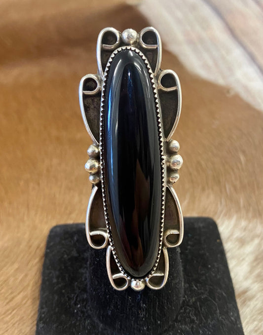 Large sterling silver black onyx single stone Native made statement size 8.5 ring. Stamped sterling and signed RM by Native American artist silversmith Ronnie Martinez. The perfect piece to add to anyone's jewelry collection. Size: 2.5” inches length x 1” inch width Ring Size: 8.5 Signed: YES "RM" Hallmark/Artist: Ronnie Martinez Stone: Onyx