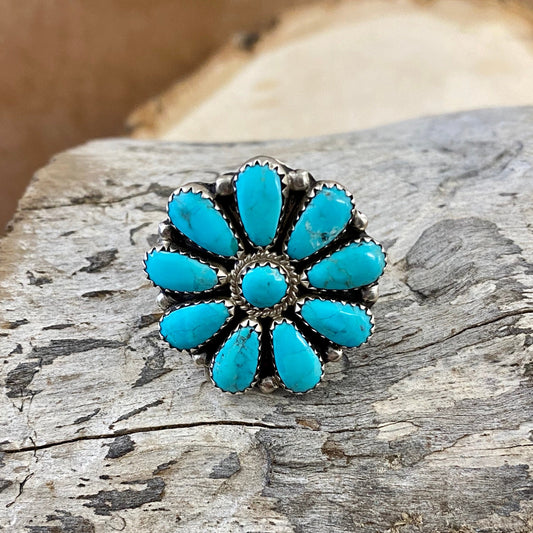 Turquoise Sterling Silver Cluster Ring Made By Native Artist Zeta BegayClusters were developed by Zuni artists in the 1920s and 30s. They started by arranging hand-cut gemstones into gorgeous designs that resembled snowflakes and flowers, among many other things. The designs were typically made with turquoise, coral and jet, but today's artists use all kinds of stones, from Spiny Oyster to Mother of Pearl.