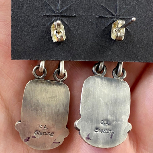 The O.A. Spiny Oyster Earrings - Ny Texas Style Boutique Red orange Spiny Oyster post sterling silver earrings. Stamped sterling and signed by Native American artist silversmith Oscar Alexius on the back. The perfect pop of color for any outfit! Size: 1.25” Inches Length Stone: Spiny Oyster Singed: YES "O.A." Hallmark/Artist: Oscar Alexius