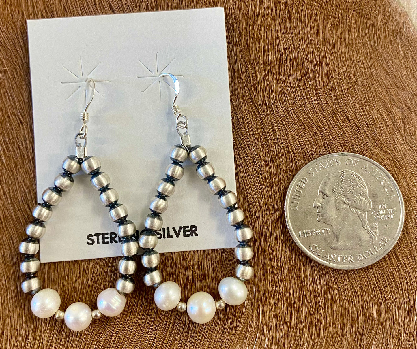 Gorgeous lightweight hand strung navajo pearl teardrop sterling silver earrings with white beads. The perfect earrings to add to anyone's jewelry collection. These Navajo pearl style teardrop earrings are hand strung together. Each of the sterling components are soldered closed to ensure durability and peace of mind. Size: 1.5” inches length x 1” inch width