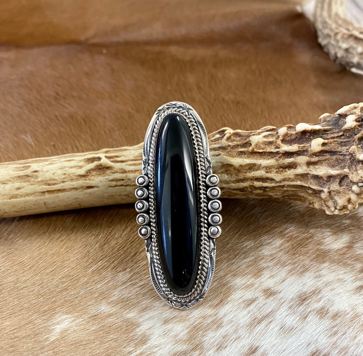 Large sterling silver onyx single stone Native made statement size 8.5 ring. Stamped sterling and signed PY by Native American artist silversmith Phillip Yazzie. The perfect piece to add to anyone's jewelry collection. Size: 2 1/4” inches length x 1” inch width Ring Size: 8.5 Signed: YES "PY" Hallmark/Artist: Phillip Yazzie Stone: Onyx
