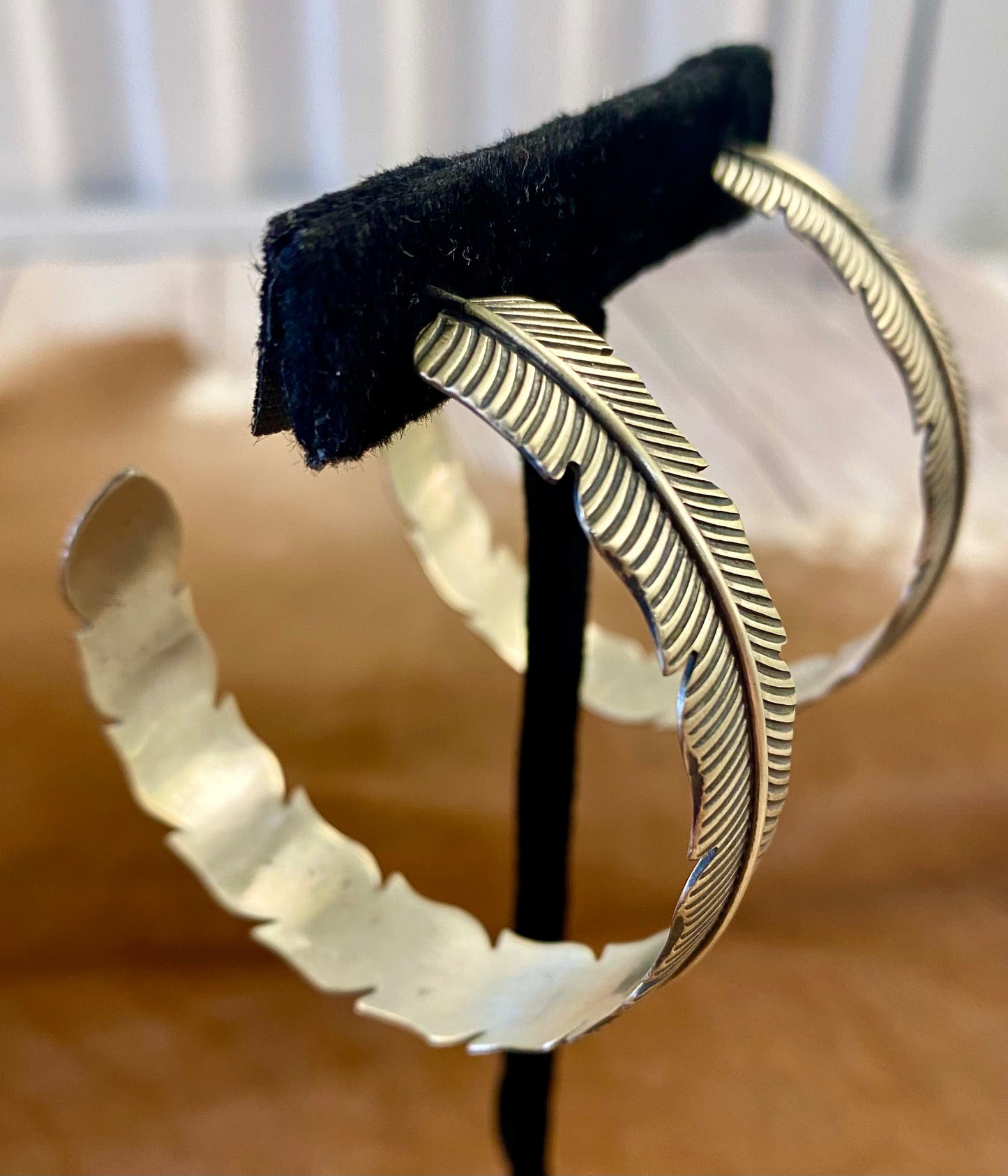 The Feather Indians Silver Earrings Stunning and unique sterling silver large feather post half hoop Native American handmade earrings. Very easy to dress up or down depending on the outfit! Add these beauties to you or your loved ones jewelry collection TODAY!   Size: 2” inch long