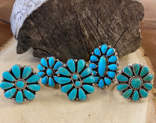 Turquoise Sterling Silver Cluster Ring Made By Native Artist Zeta BegayClusters were developed by Zuni artists in the 1920s and 30s. They started by arranging hand-cut gemstones into gorgeous designs that resembled snowflakes and flowers, among many other things. The designs were typically made with turquoise, coral and jet, but today's artists use all kinds of stones, from Spiny Oyster to Mother of Pearl.