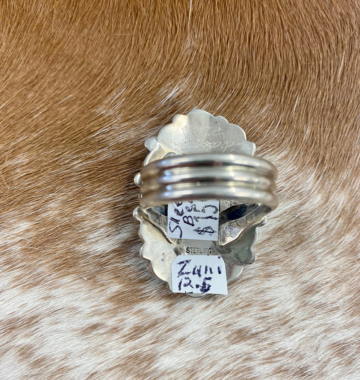 Sleeping Beauty turquoise traditional cluster sterling silver ring. Stamped sterling and signed on the back by a Zuni Native American artist silversmith. Available in size 12 1/2. The perfect piece to add to your accessory wardrobe and jewelry collection.   Size: 1.5 Inches Length X 1” Inch Width    Stone: Sleeping Beauty Turquoise   Signed: YES