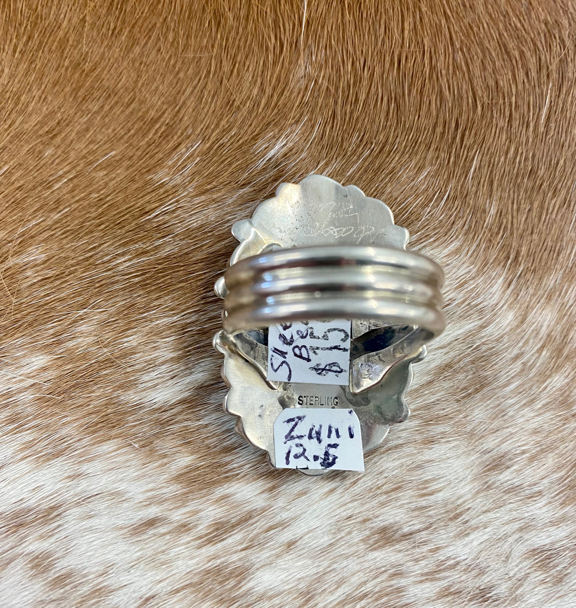 Sleeping Beauty turquoise traditional cluster sterling silver ring. Stamped sterling and signed on the back by a Zuni Native American artist silversmith. Available in size 12 1/2. The perfect piece to add to your accessory wardrobe and jewelry collection.   Size: 1.5 Inches Length X 1” Inch Width    Stone: Sleeping Beauty Turquoise   Signed: YES