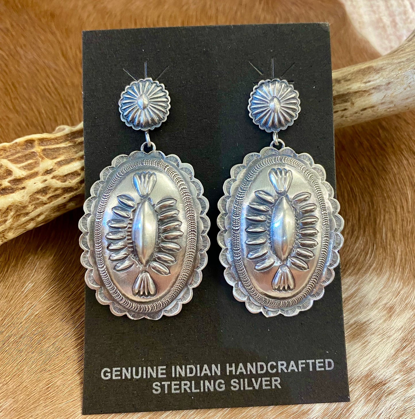 Stunning large statement Concho post sterling silver Native American made signed earrings. The perfect earrings to add to anyone's jewelry collection. The stamping adds a unique and elegant look. Handmade by Native American artist silversmith D Tom Charlie. Size: 2” inch length Signed: YES Hallmark/Artist: D Tom Charlie The Creager Silver Concho Earrings By D Tom Charlie