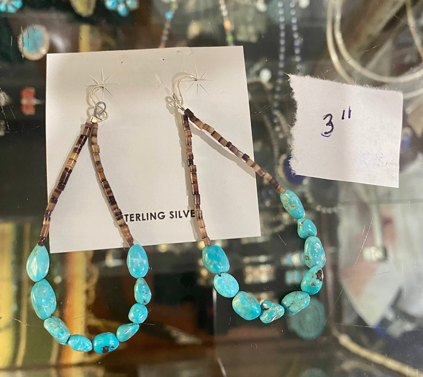 Beautiful Heshie Native American-made teardrop drop hook earrings with turquoise. The ideal jewelry item to give as a present or to keep for yourself! These are light and straightforward while still being elegant. The perfect turquoise teardrop earrings for anyone's jewelry collection! Size: 3” inch length Stone: Turquoise
