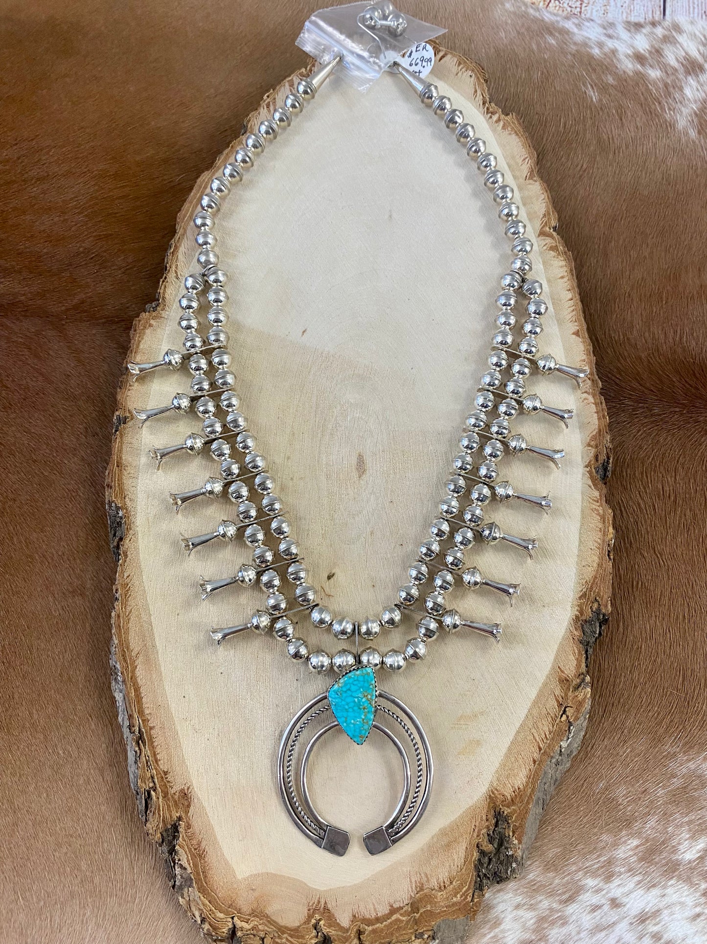 Gorgeous sterling silver handmade Turquoise Squash Blossom necklace stamped STERLING and signed with the initials “PG” on the back of the naja by the artist. A photo of the hallmark will be in the photos above. This necklace will make for a stunning addition to anyone’s jewelry collection. A statement piece for any outfit! The perfect amount of silver and turquoise is handcrafted into this unique piece.