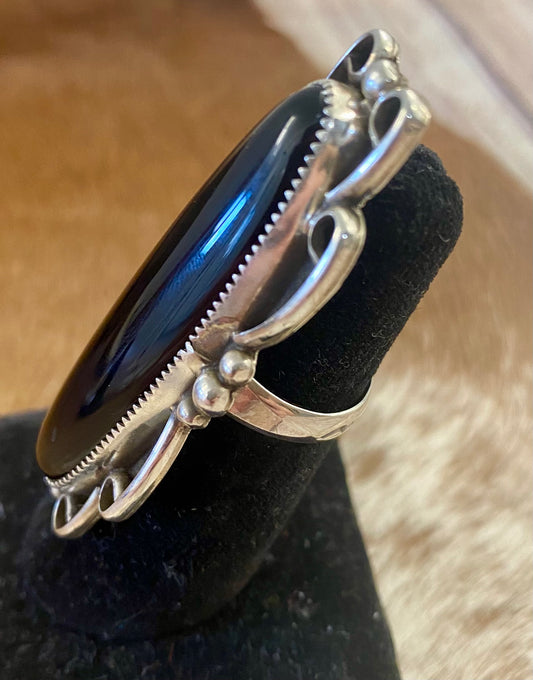 Large sterling silver black onyx single stone Native made statement size 8.5 ring. Stamped sterling and signed RM by Native American artist silversmith Ronnie Martinez. The perfect piece to add to anyone's jewelry collection. Size: 2.5” inches length x 1” inch width Ring Size: 8.5 Signed: YES "RM" Hallmark/Artist: Ronnie Martinez Stone: Onyx
