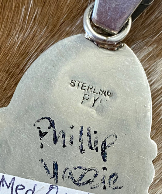 The perfect single stone sterling silver Native American made onyx pendant to add to any necklace. This piece will look especially gorgeous on a strand of Navajo pearls. Stamped sterling and signed PY by Native artist silversmith Phillip Yazzie. Size: 2” inches length without bale x 1” inch width - 1” inch bale Signed: YES "PY" Hallmark/Artist: Phillip Yazzie Stone: Onyx