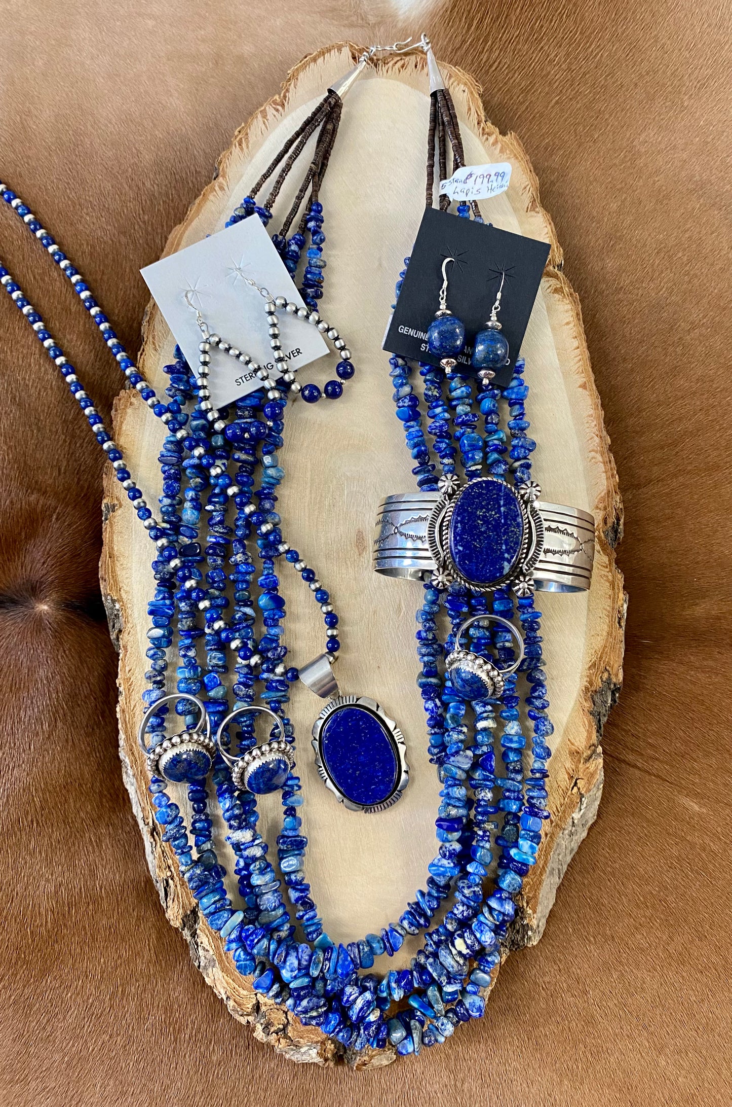 Gorgeous lightweight hand-strung Navajo pearl teardrop sterling silver lightweight earrings with three pieces of blue lapis stones at the bottom of each teardrop earring. The perfect earrings to add a pop of blue to any outfit! Size: 1.5” inches length x 1” inch width Stone: Blue Lapis & Navajo Pearl