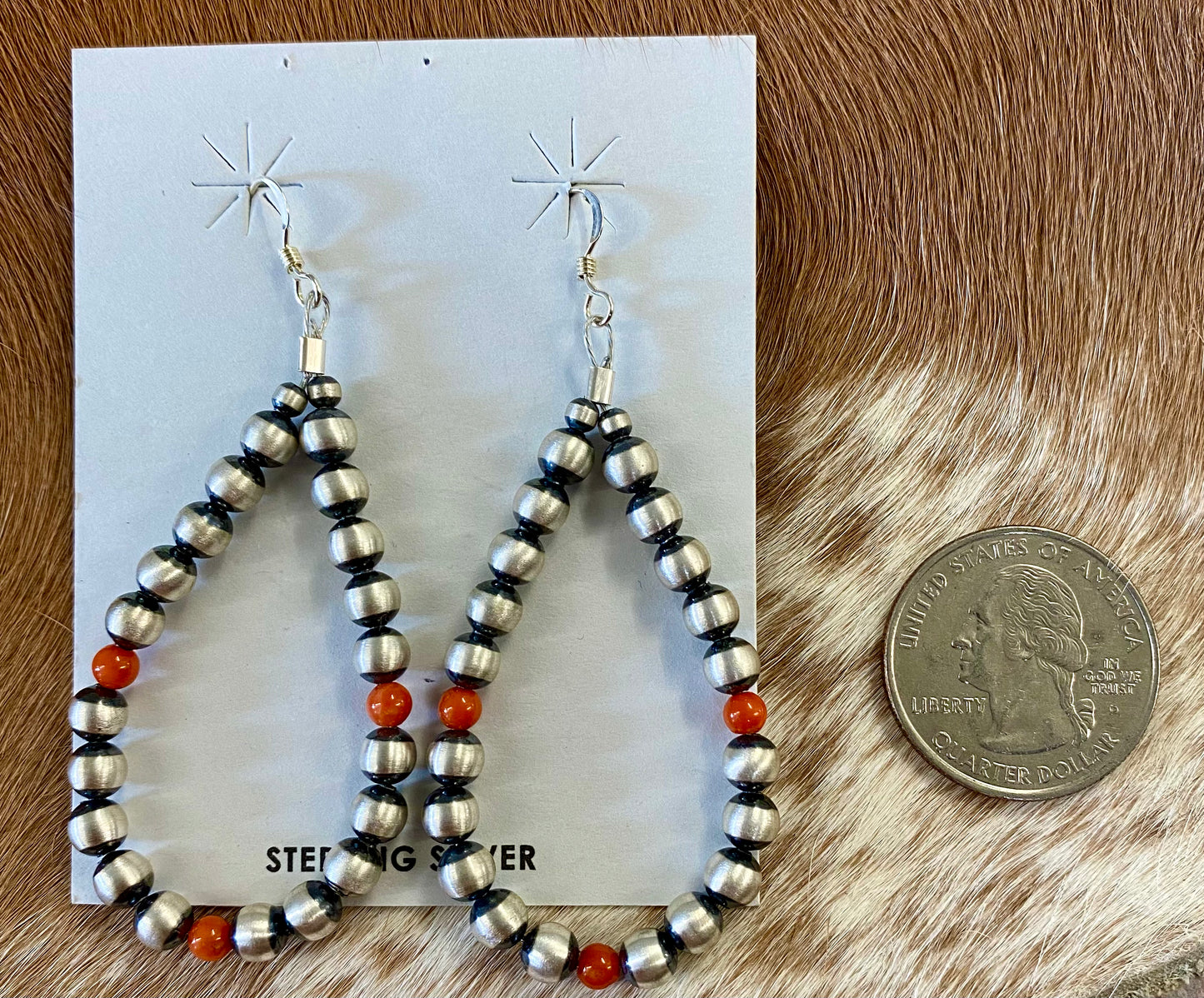 Stunning hook lightweight orange coral native hand strung sterling silver teardrop earrings. The perfect earrings for the fall weather headed our way! The perfect earrings to add to your jewelry collection or gift to a loved one. These Navajo pearl style teardrop earrings are hand strung together. Each of the sterling components are soldered closed to ensure durability and peace of mind. Size: 2.5” Inches length x 1.25” inches width Stone: Coral
