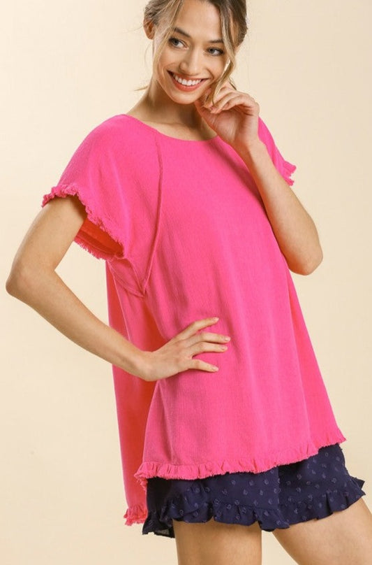 Pink Short Sleeve Top Soft and comfy pink short sleeve top featuring a round neckline. Has textured hems on the bottom and sleeves for the perfect touch of flare. This pink short sleeve top will be a lovely, basic, and original addition to your wardrobe. The perfect pink short sleeve top to dress up or down for a variety of summertime events and occasions!