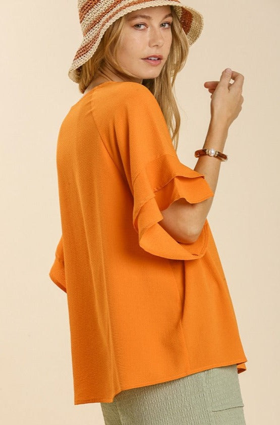 Orange Ruffle Sleeve Top Women's orange short sleeve shirt with a round neckline is extremely comfortable. The right degree of flair is added by the tiered ruffle sleeves on this orange blouse. This orange short sleeve blouse for women will be a charming, fundamental, and distinctive addition to your closet. 