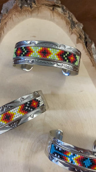 Beautiful unique stamped Nickle sliver and signed by Native American artist silversmith inside of the cuff band. Aztec seed beaded bright colorful Nickle silver cuff bracelet. Size: 5” inches inside measurement - gap 1-1.5” inches The Texas Queen Aztec Beaded Cuff
