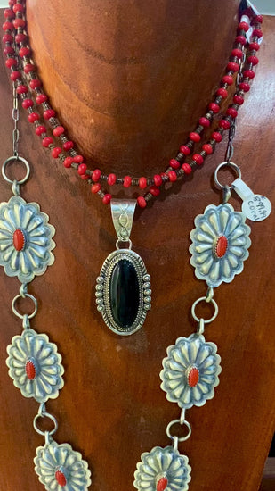 Beautiful seven silver and coral Concho long 30" inch length sterling silver Native American made necklace. The piece is stamped sterling and signed "DM" on the back of the necklace.   Size: 30" Inches length   Stone: Coral  Signed: YES "DM"   Hallmark/ Artist: DM Begay