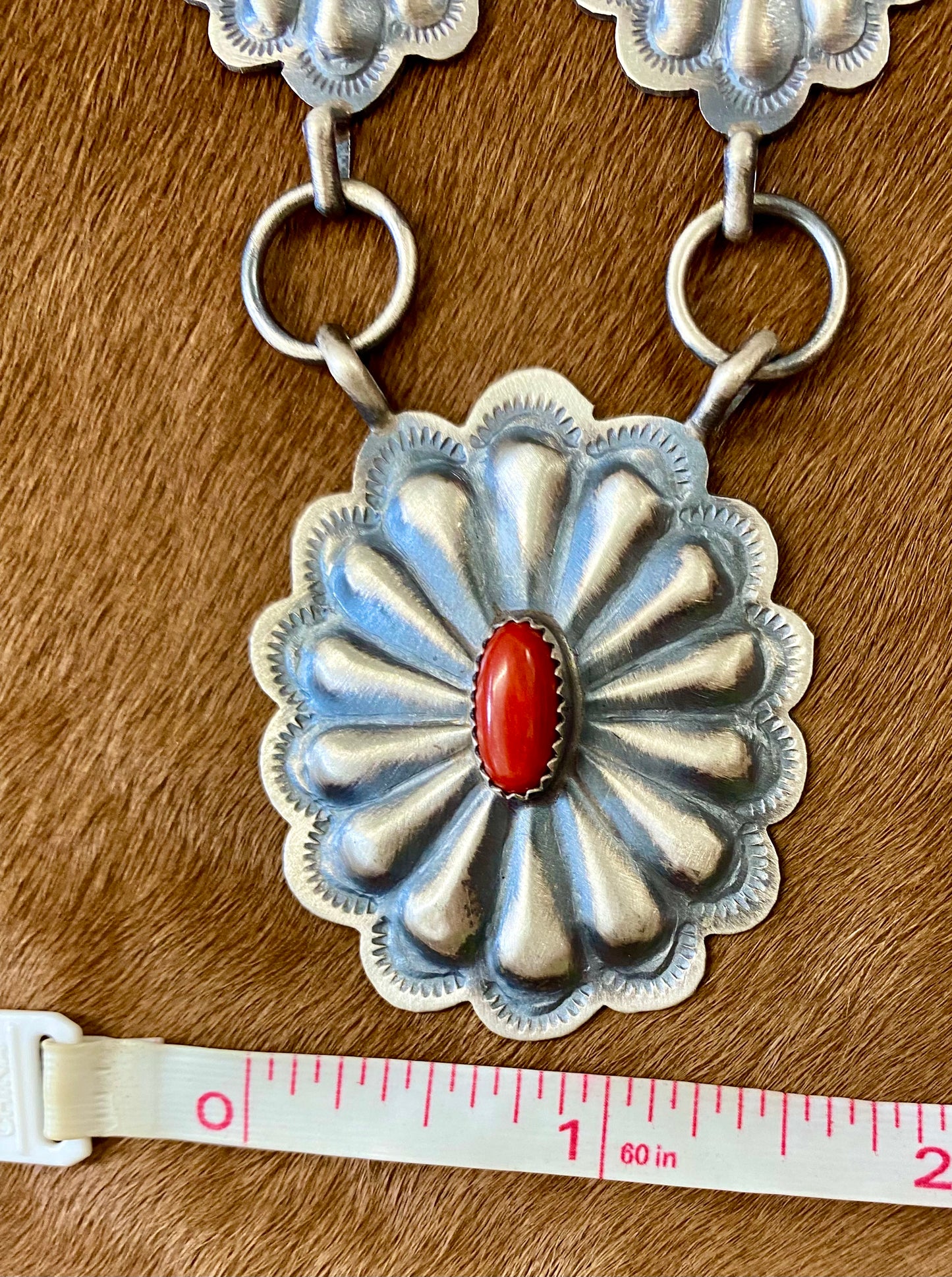 Beautiful seven silver and coral concho long 30" inch length sterling silver Native American made necklace. The piece is stamped sterling and signed "DM" on the back of the necklace.   Size: 30" Inches length   Stone: Coral  Signed: YES "DM" Handmade Concho Coral Sterling Silver Native American Made Necklace