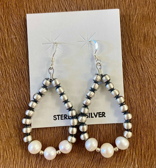 Gorgeous lightweight hand strung navajo pearl teardrop sterling silver earrings with white beads. The perfect earrings to add to anyone's jewelry collection. These Navajo pearl style teardrop earrings are hand strung together. Each of the sterling components are soldered closed to ensure durability and peace of mind. Size: 1.5” inches length x 1” inch width