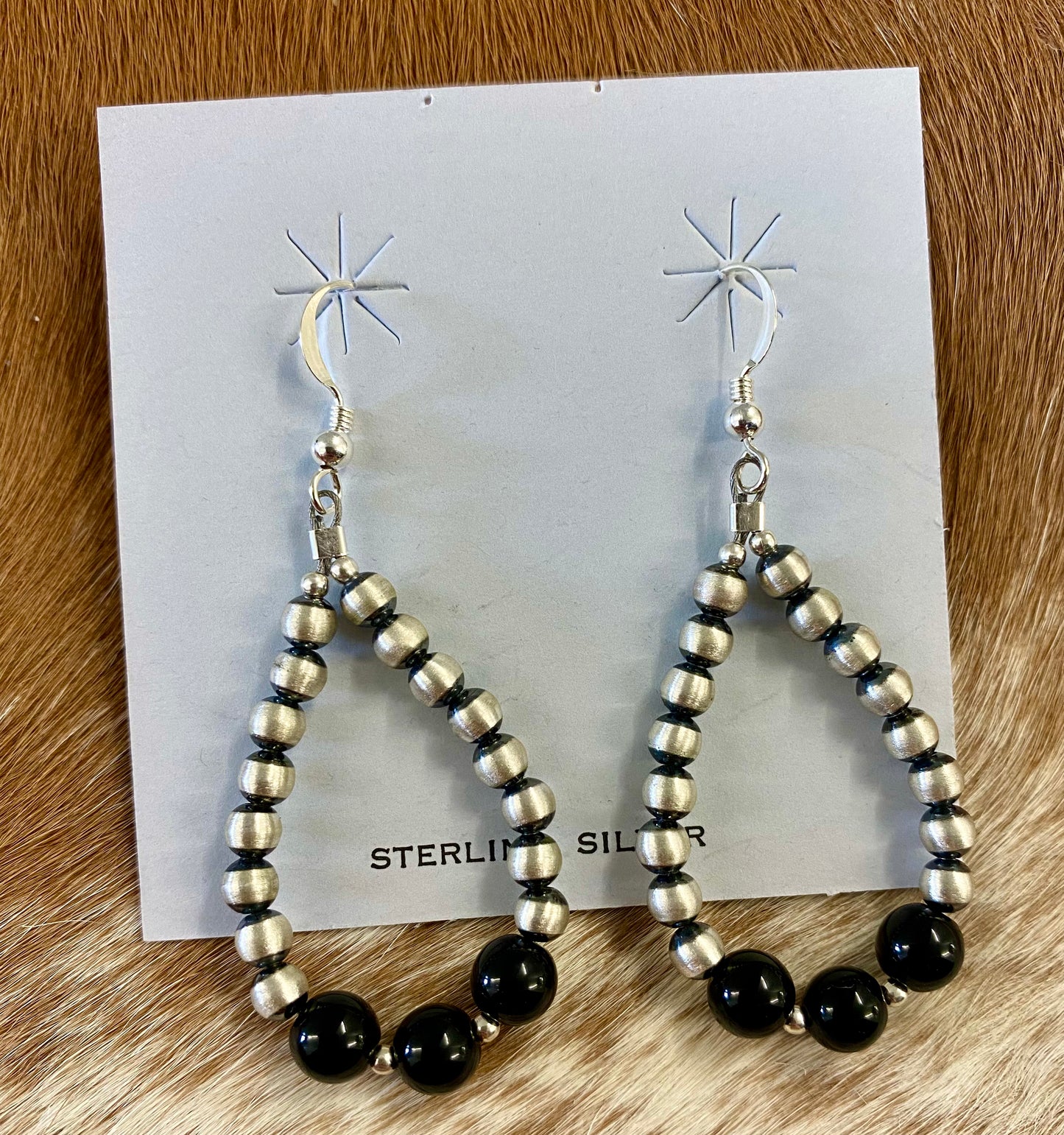 ﻿Stunning lightweight teardrop shape hook simple yet elegant sterling silver Navajo Pearl earrings with onyx. These Navajo pearl style teardrop earrings are hand strung together. Each of the sterling components are soldered closed to ensure durability and peace of mind.  Size: 2” inches length x 1” inch width   Stone: Onyx 