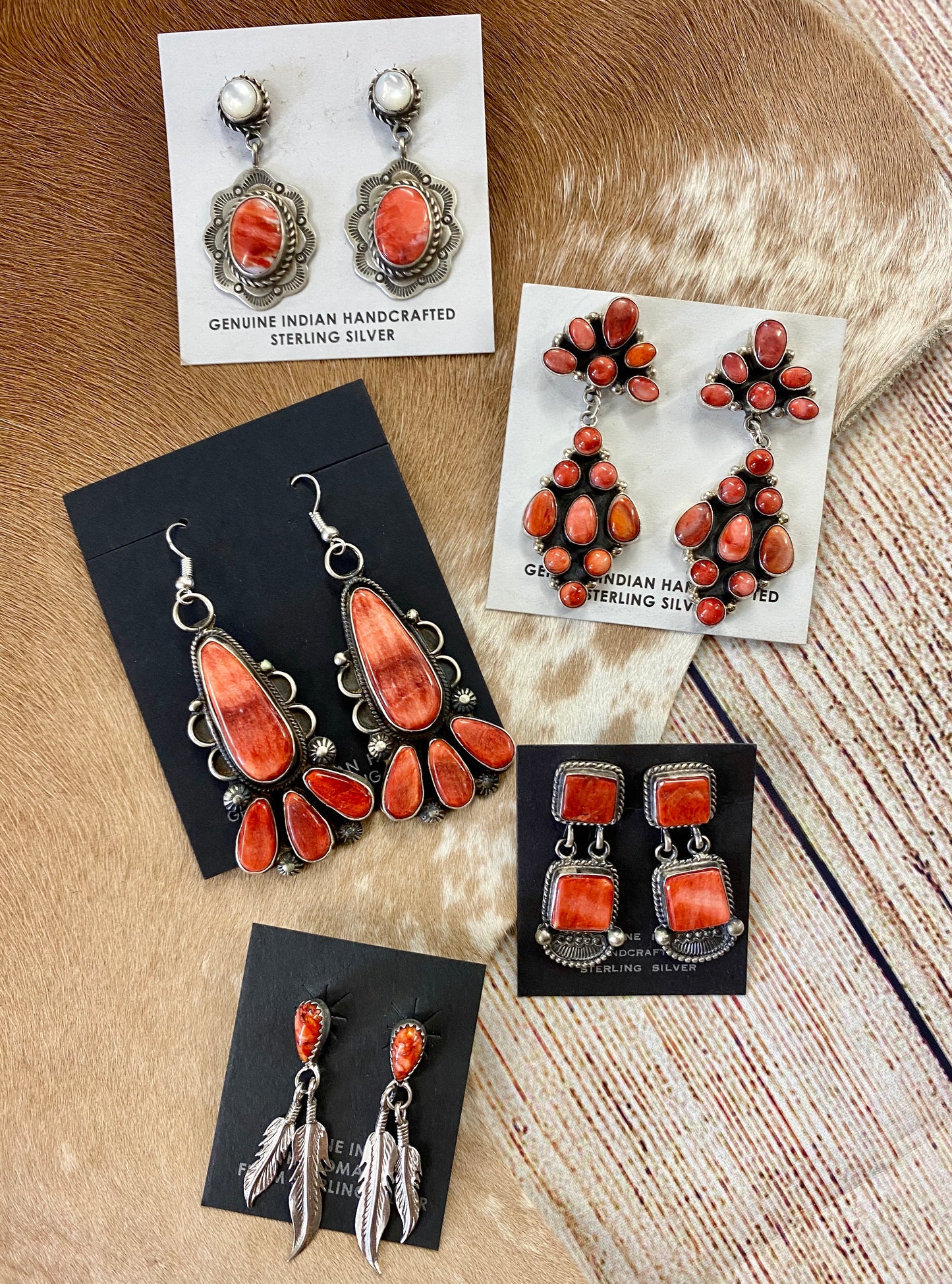 The O.A. Spiny Oyster Earrings - Ny Texas Style Boutique Red orange Spiny Oyster post sterling silver earrings. Stamped sterling and signed by Native American artist silversmith Oscar Alexius on the back. The perfect pop of color for any outfit!   Size: 1.25” Inches Length   Stone: Spiny Oyster  Singed: YES "O.A."   Hallmark/Artist: Oscar Alexius 