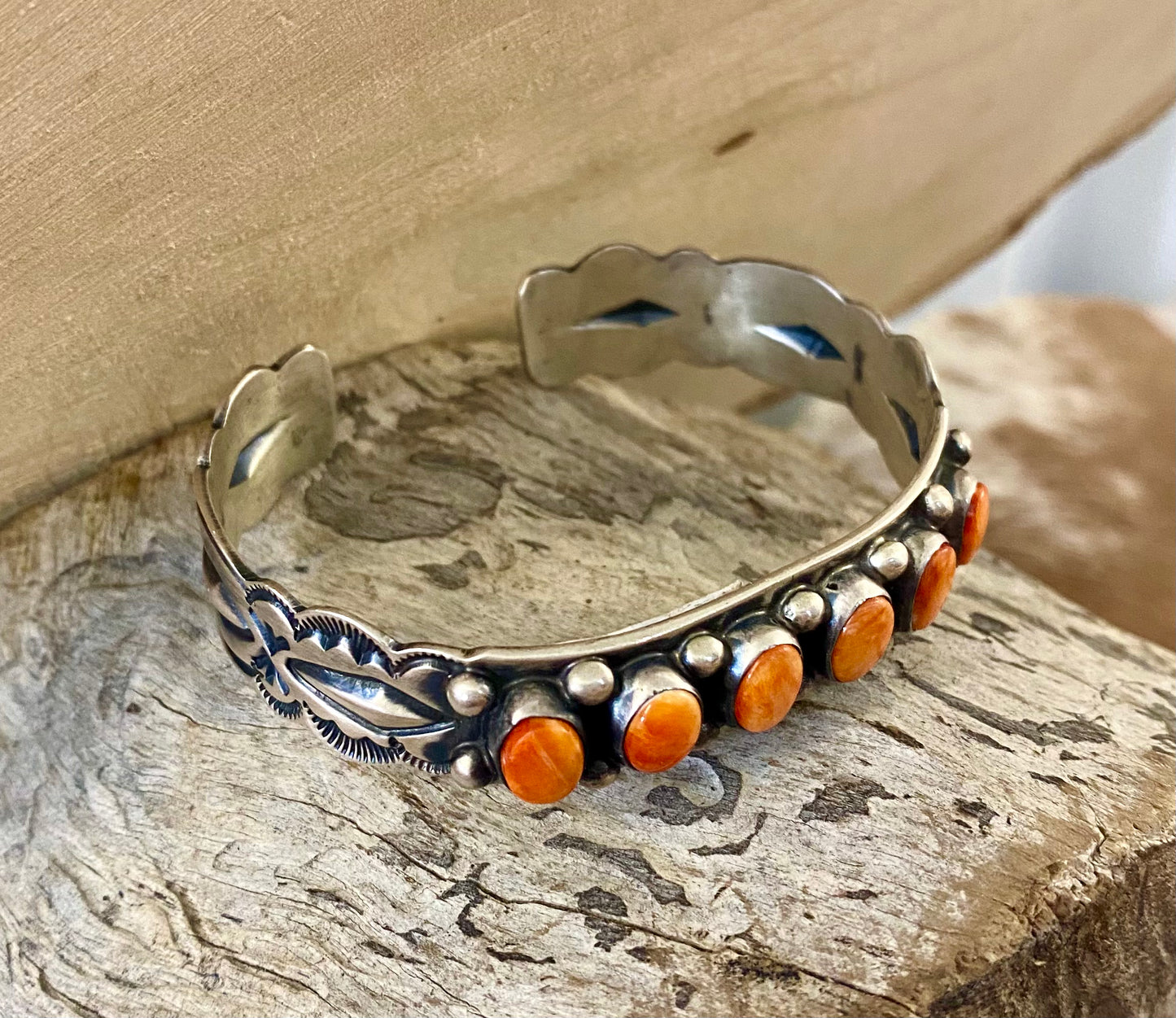 Aldine Orange Spiny Oyster Sterling Silver Cuff | Native Made Jewelry Stunning sterling silver native made stamped six stone orange spiny oyster cuff. Stamped sterling and signed on the inside of the cuff with the initial L by artist silversmith. Please see photos above for exact hallmark. This piece is gorgeous from every angle and will make a statement with any outfit. 