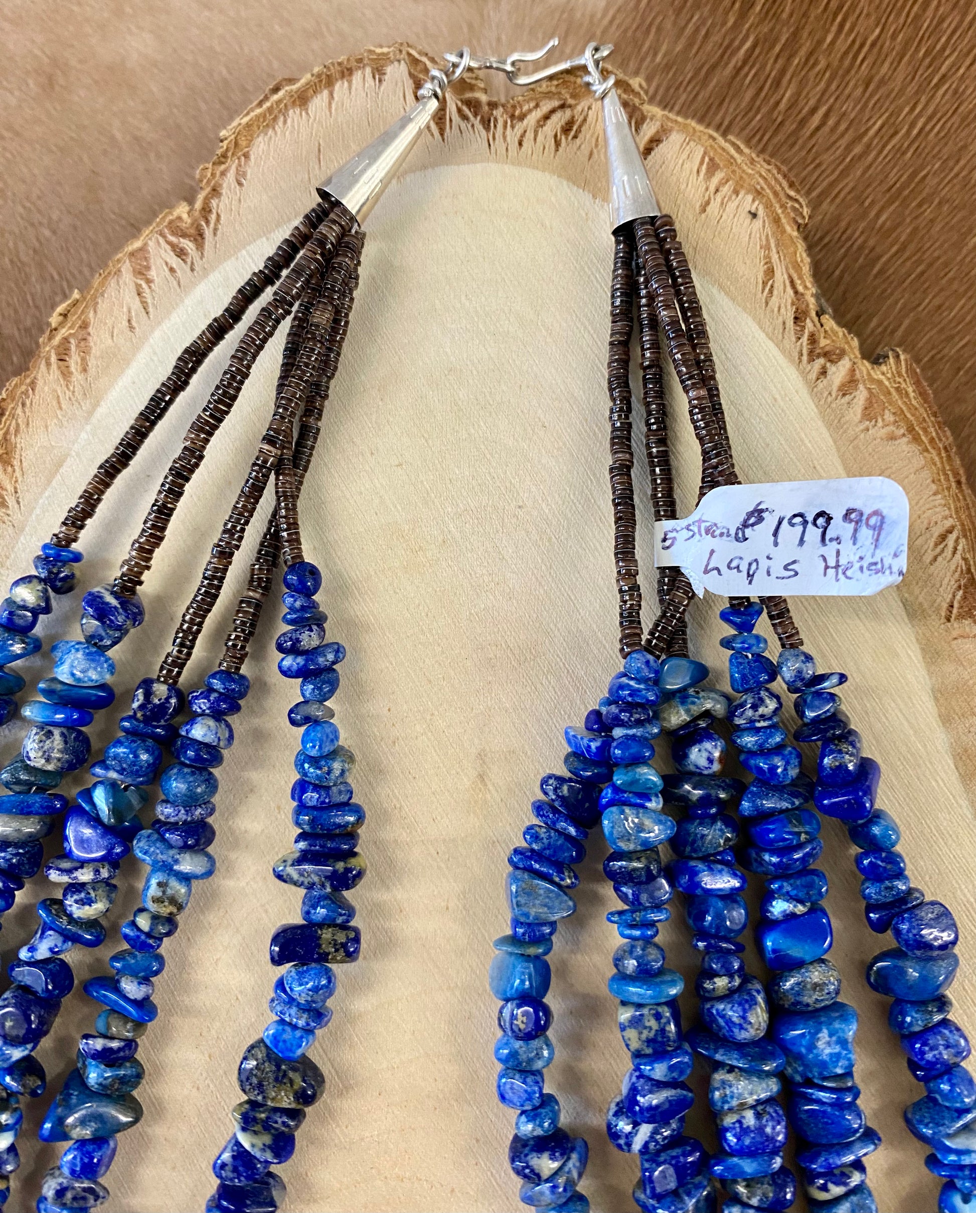 Absolutely stunning sterling silver clasp five strand hand strung blue Lapis and heishe 27” inch length necklace. The shades of blue in this piece are out of this world amazing! This necklace will make a statement with any outfit.   Size: 27" Inches Length   Stone: Blue Lapis 