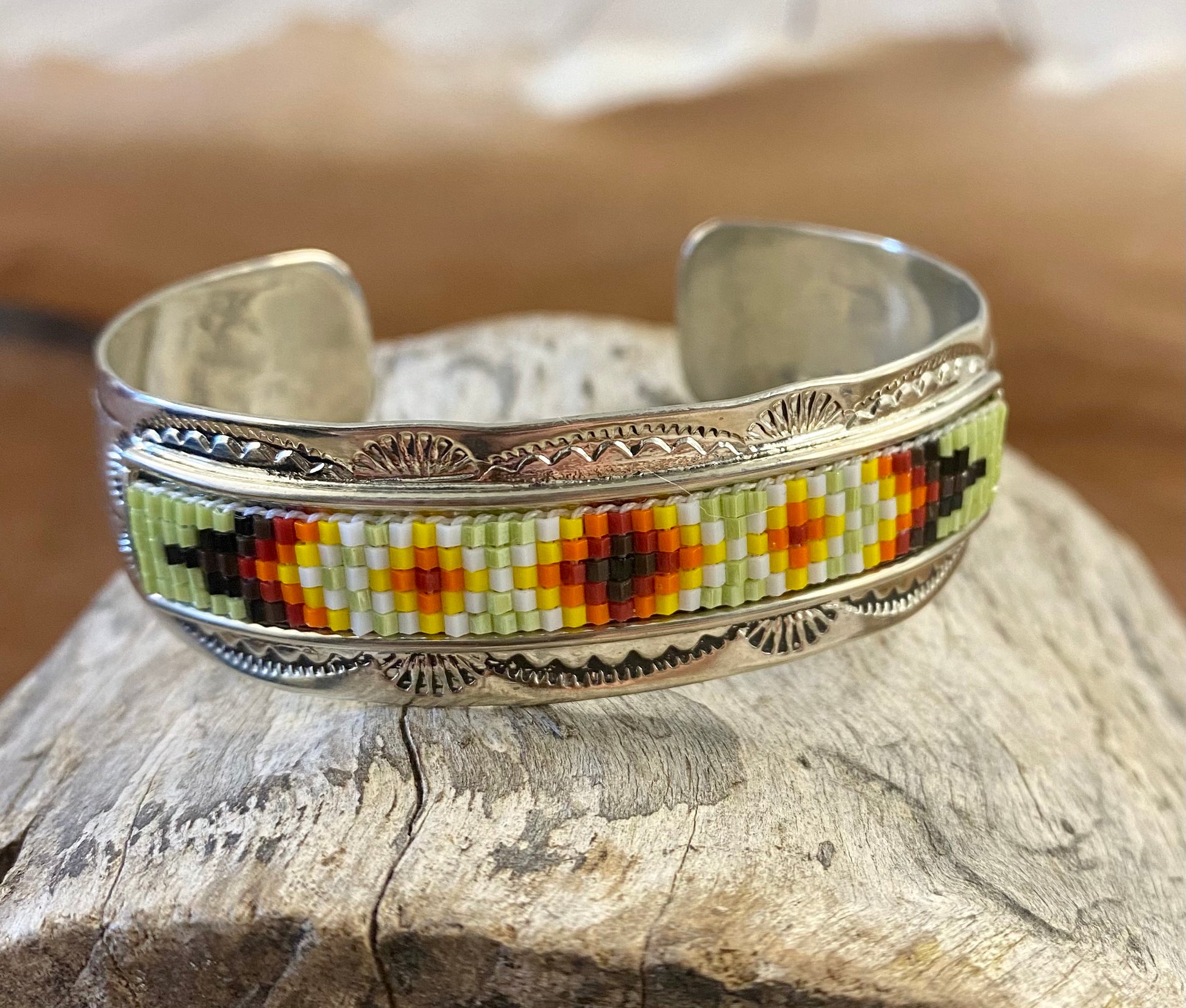 Beautiful unique stamped Nickle sliver and signed by Native American artist silversmith inside of the cuff band. Aztec seed beaded bright colorful Nickle silver cuff bracelet.   Size: 5” inches inside measurement - gap 1-1.5” inches 