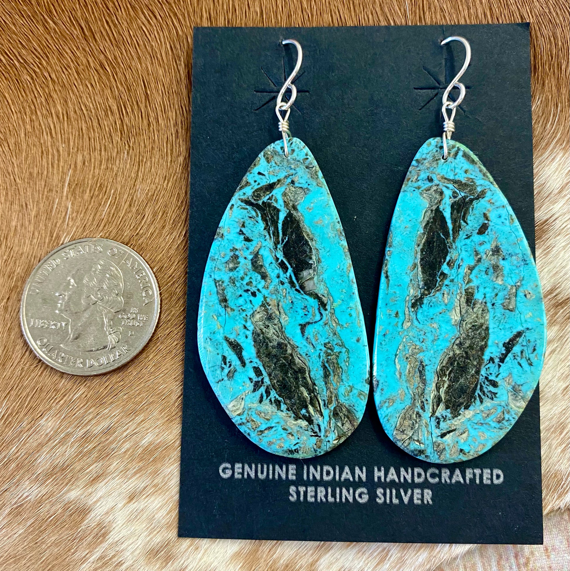 Large statement sterling silver handmade Native American made turquoise slab earrings. These are gorgeous and will make a statement with any outfit, any jewelry collection! These are made by Native American artist silversmith Ron Chavez.   Size: 2” inch length   Artist/Hallmark: Ron Chavez   Stone: Turquoise 