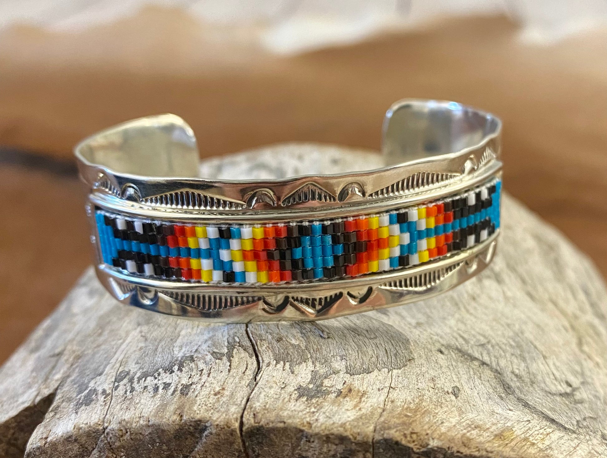 Beautiful unique stamped Nickle sliver and signed by Native American artist silversmith inside of the cuff band. Aztec seed beaded bright colorful Nickle silver cuff bracelet.   Size: 5” inches inside measurement - gap 1-1.5” inches  The Sundance Aztec Beaded Cuff