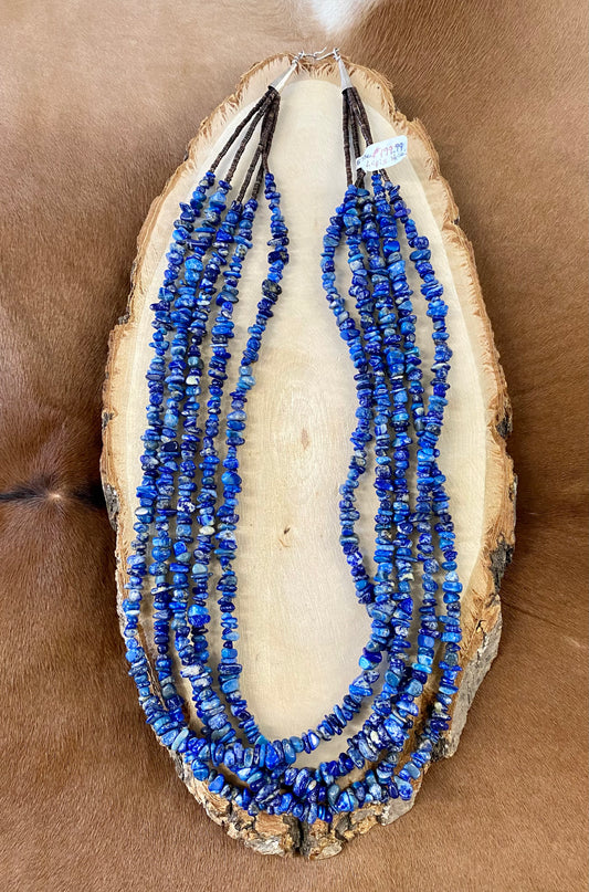 Absolutely stunning sterling silver clasp five strand hand strung blue Lapis and heishe 27” inch length necklace. The shades of blue in this piece are out of this world amazing! This necklace will make a statement with any outfit.   Size: 27" Inches Length   Stone: Blue Lapis 