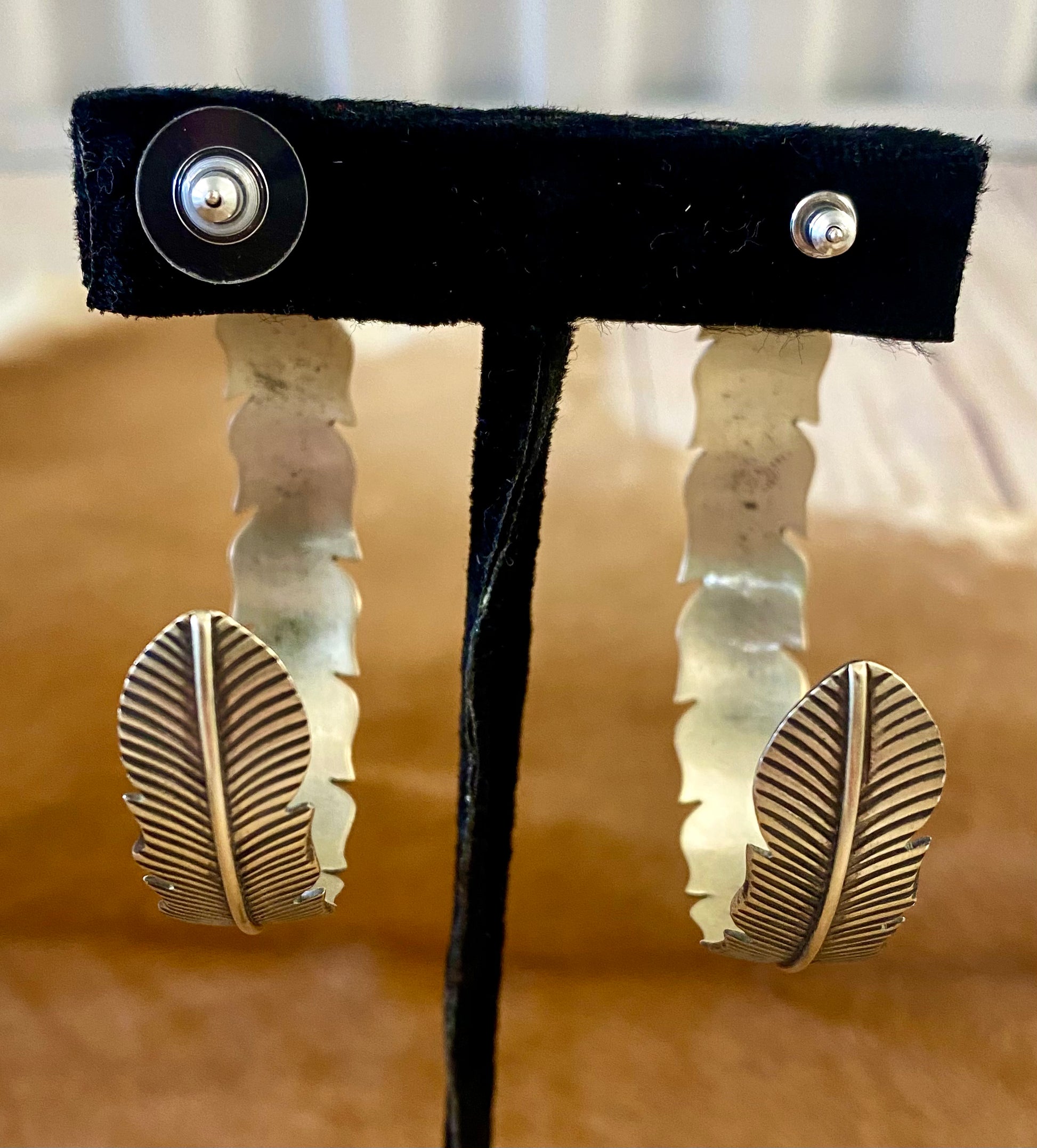 The Feather Indians Silver Earrings Stunning and unique sterling silver large feather post half hoop Native American handmade earrings. Very easy to dress up or down depending on the outfit! Add these beauties to you or your loved ones jewelry collection TODAY!   Size: 2” inch long 