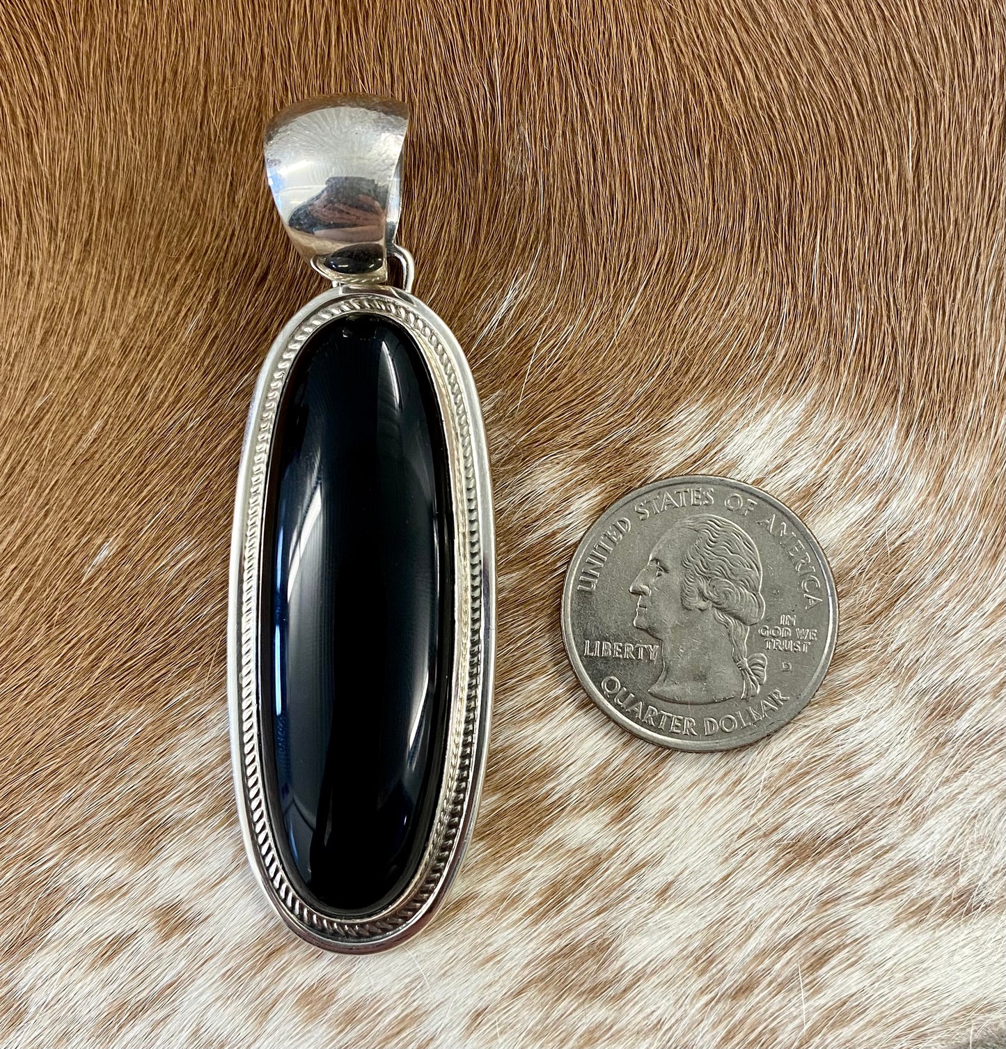 The perfect single-stone sterling silver Native American-made large black onyx pendant to add to any necklace. This piece will look gorgeous on a strand of Navajo pearls or a chain necklace. Stamped sterling and signed Harley Jake by Native artist silversmith Harley Jake on the back of the pendant.   Size: 2” inch length, bale 1/2” inch. 1" inch width   Signed: YES "Harley Jake"   Hallmark/ Artist: Harley Jake  Stone: Onyx