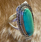 Beautiful simple and elegant Native made sterling silver single stone turquoise ring. Stamped .925 and signed "R.B." inside of a bear icon for Running Bear Shop. The perfect everyday turquoise ring!   Size: 1.25” inches length x .5” inch width   Ring Size: 7  Signed: YES "R.B."   Hallmark/Artist: Running Bear Shop   Stone: Turquoise 