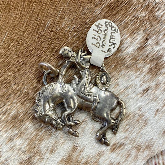 Bucking bronco cowboy sterling silver pendant/charm. The perfect addition to anyone's jewelry collection. This piece is stamped, please see photos below for hallmark. This pendant is so fun and unique. It would make for a beautiful addition to your next outfit or gift it to a loved one! Size: 1.25” Inches length Signed: Yes