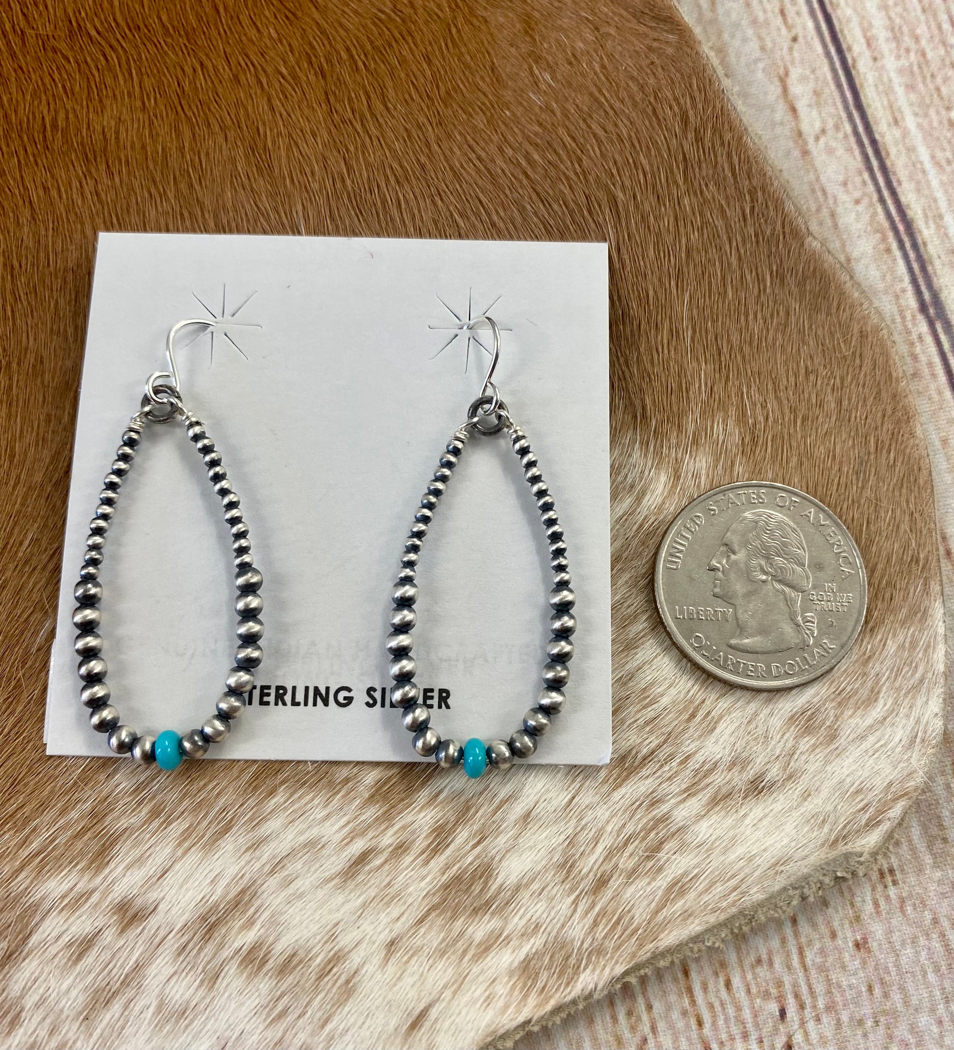 Simple lightweight and gorgeous authentic hand-strung Navajo Pearl sterling silver teardrop earrings with a turquoise stone on the bottom of each earring. Hook-closure earrings are perfect for everyday casual outfits and dressed-up ones.   Size: 1.5" inches length earrings.  Stone: Navajo Pearl & Turquoise 