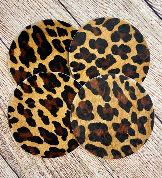 A beautiful set of leopard print cowhide coasters that will look great on any table, counter or shelf. Each one is made from natural cowhide leather, meaning they are durable, able to absorb moisture and easy to clean. These beautiful hair-on-hide rustic leather coasters are great gifts for weddings, showers, birthdays, holidays or any other special occasion. They protect your furniture while also adding a little western touch to the room. Perfect for your living spaces and offices. 