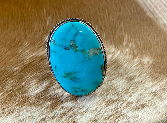 Sterling Silver Turquoise Adjustable Ring By Navajo Artist Ray Tafoya Large 1.5” inches length turquoise single stone sterling silver adjustable ring. Stamped sterling and signed “RT” inside of the ring band by Native American artist silversmith Ray Tafoya. Stunning unique statement turquoise large single stone piece. The perfect addition to add to your next look.   Size:  1.5” Inches Length  Adjustable Size  Hallmark/Artist: Ray Tafoya  Signed: YES "RT"