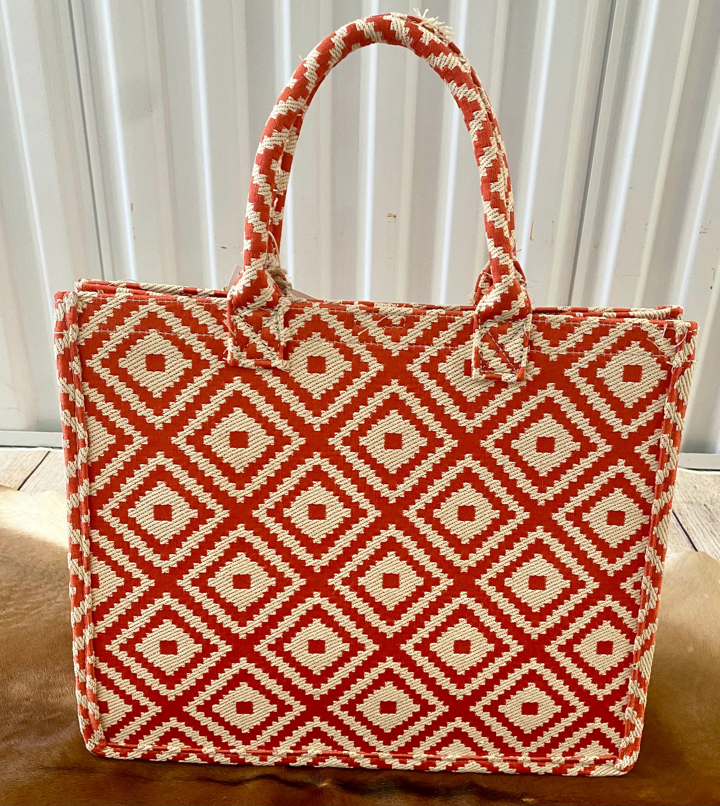 Perfect for summer coral color geometric patterned tote bag. The essential beach and vacation tote purse that will keep you stylish and kept together.   Size : 14" X 6" X 11.5" Material : 100% PolyesterThe Anglo Coral Geometric Patterned Large Tote Bag