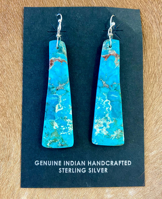 ﻿Gorgeous unique large turquoise slab sterling silver Native American made earrings. Beautiful statement handmade earrings, perfect for so many different occasions. From weddings, NFR, to everyday wear!   Size: 2” inch length   Stone: Turquoise Native American Made Sterling Silver Large Turquoise Slab Earrings