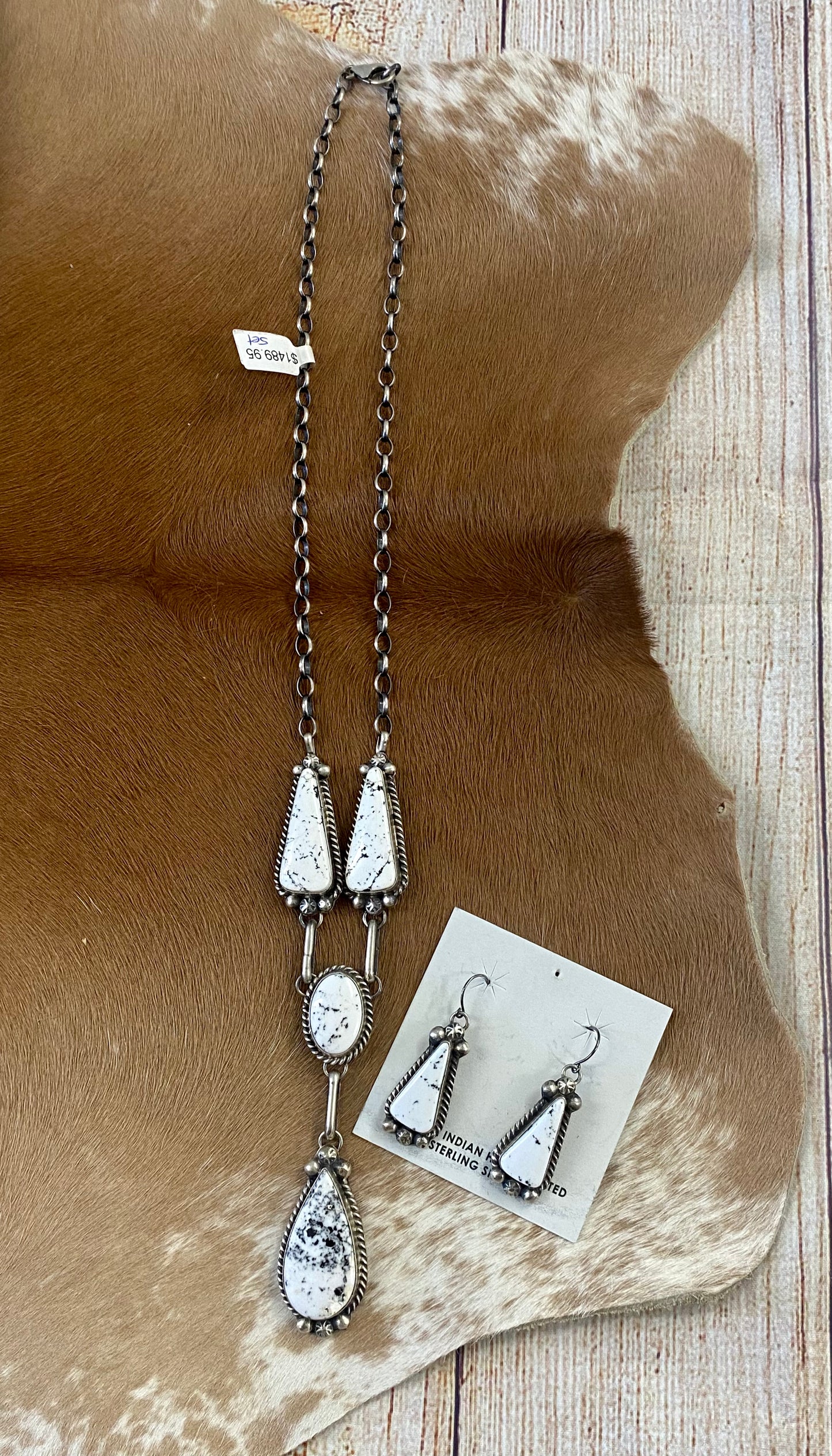 Stunning White Buffalo lariat style sterling silver Native American made necklace and drop hook matching White Buffalo sterling silver earrings set. The perfect jewelry set to gift to your loved one or keep for your own jewelry collection! Both pieces are stamped sterling and signed on the back by talented artist silversmith Annie Spencer.   Size: 27” inches in length necklace + 1 1/2” inch earrings   Stone: White Buffalo  Signed: YES "AL"  Artist / Hallmark: Annie Spencer
