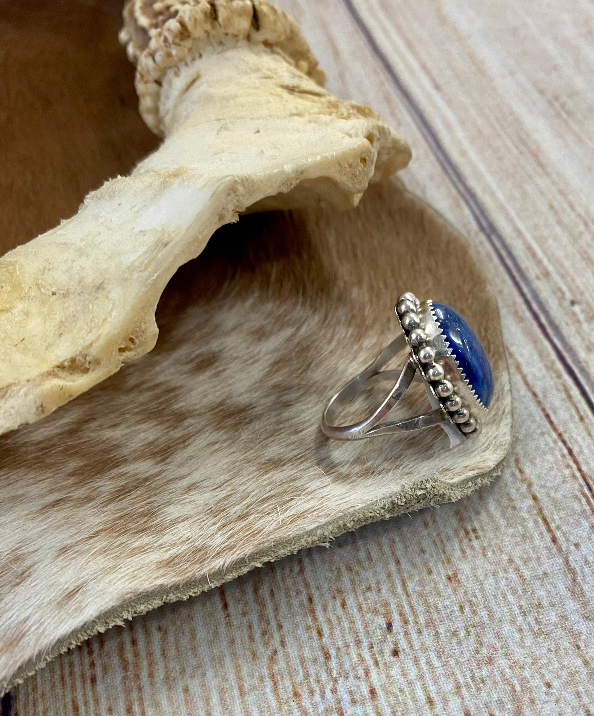 Beautiful single stone simple yet striking sterling silver blue lapis round size 7 ring. This piece is stamped Sterling and signed B on the back by Native American artist silversmith. A gorgeous ring that will add a pop of color to any outfit.   Signed: YES “B”  Ring Size: 7  Size: 1” inch length   Stone: Blue Lapis 